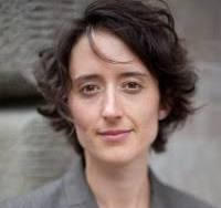 An attractive brown haired women looking directly into the camera